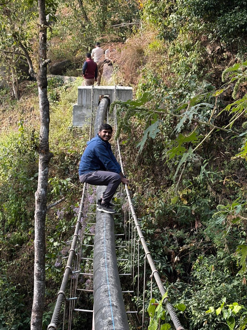Pipeline crossing through steep forested terrain