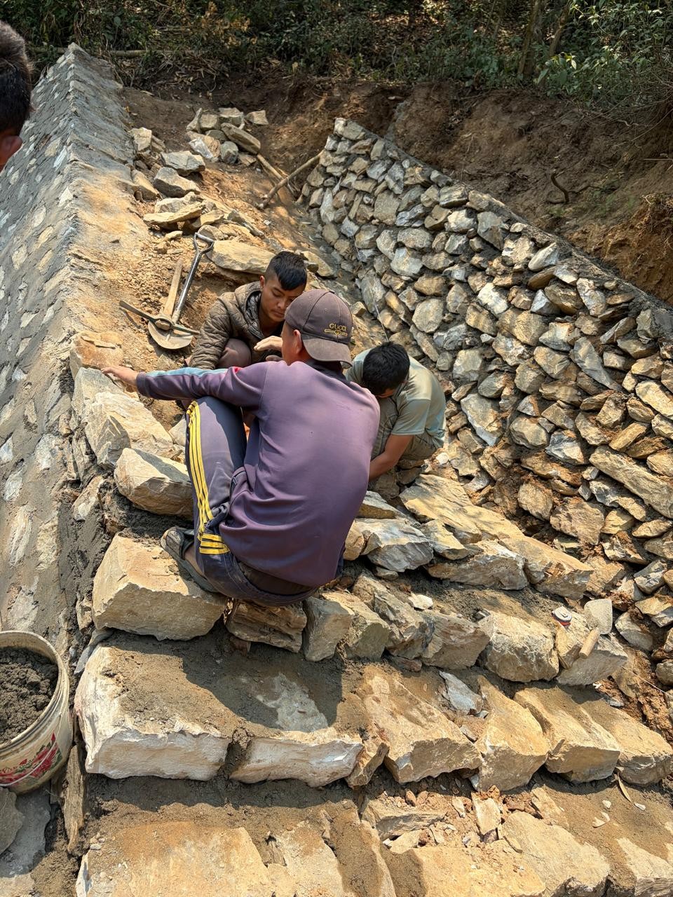 Masonry construction and drainage work in progress