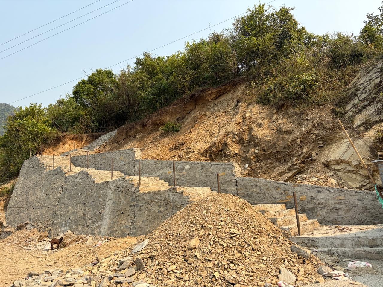 Large masonry retaining and stair structure on steep terrain